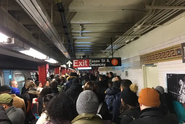A crowded M train platform at Delancey/Essex after a person was truck by a train at Herald Square this morning.